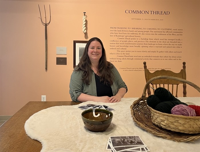 Supervisor at Kamloops Museum and Archives, Julia Cyr sits in an exhibit called Common Threads. 