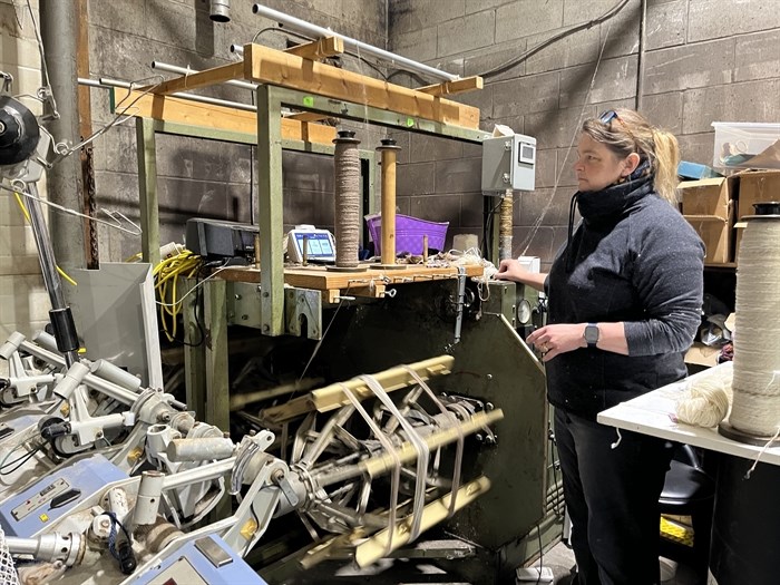 Owner at a fiber mill in Kamloops, Nicole Link winds yarn into skeins. 