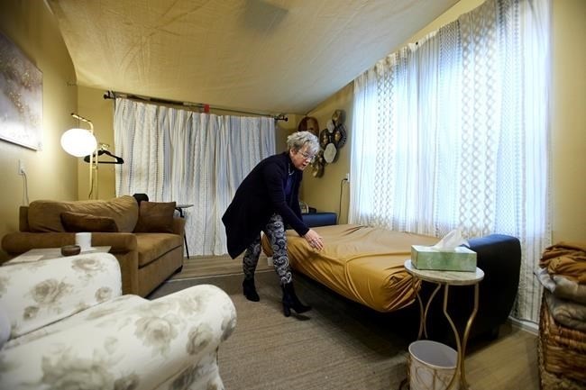 MJ Wilt, a licensed psilocybin facilitator and the owner of a licensed psilocybin service center, sets up a room for a patient journey at her facility in Gresham, Ore., Monday, Nov. 18, 2024.