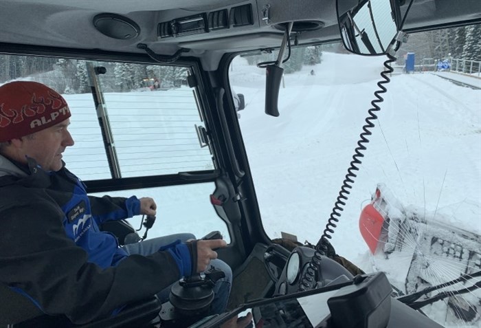 Slopes manager Seth Worthen plows snow at the base, while several other machines are scattered around the resort.