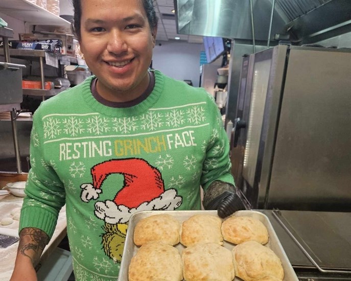 Elija Mack-Stirling, owner of Kekuli Cafe in Kamloops and Merritt, pulls baked Bannock out of the oven at the Kamloops location.