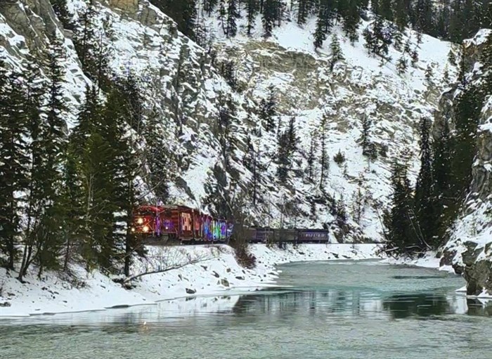 The CPKC Holiday Train rolls through snowy trees in Golden on Dec. 16, 2024.