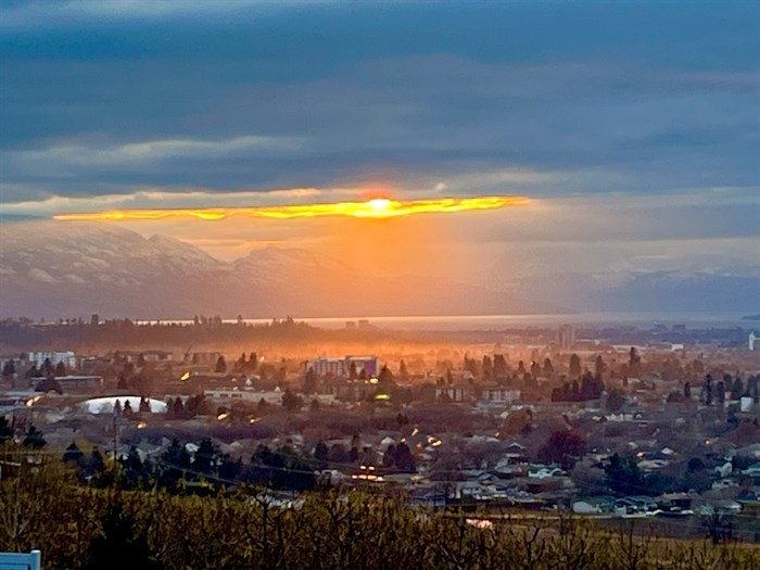 Some snow can be seen on the hilltops in this photo of the sun rising in the Central Okanagan in winter. 