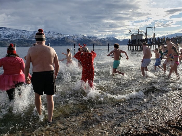 Polar plungers in Peachland run into Okanagan Lake for the annual Dash and Splash event on New Year's Day, 2020. 