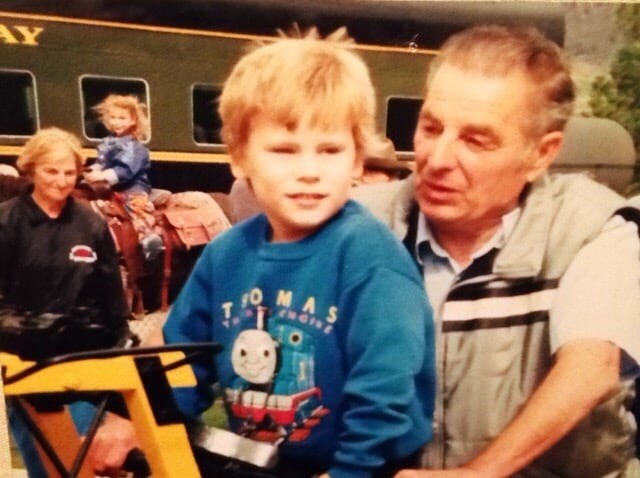 Leader of railway development at Kamloops Heritage Railway, Jordan Popadynetz is seen at age five in front of locomotive #2141 beside his grandfather in 2002.