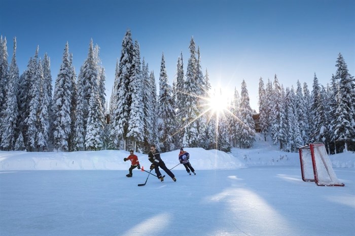 Outdoor enthusiasts play hockey at the ice rink at SilverStar Mountain Resort. 