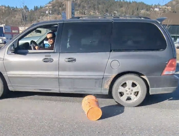 The driver in the social media video after throwing a bucket filled with pieces of metal out the window.