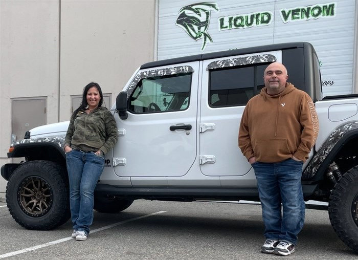 Jenn Wood and carbon fibre repair expert, Kenny, outside Liquid Venom Customs in West Kelowna, BC.