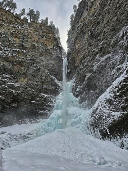 Frozen Spahats Creek Falls in Wells Gray Provincial Park has blue hues.  