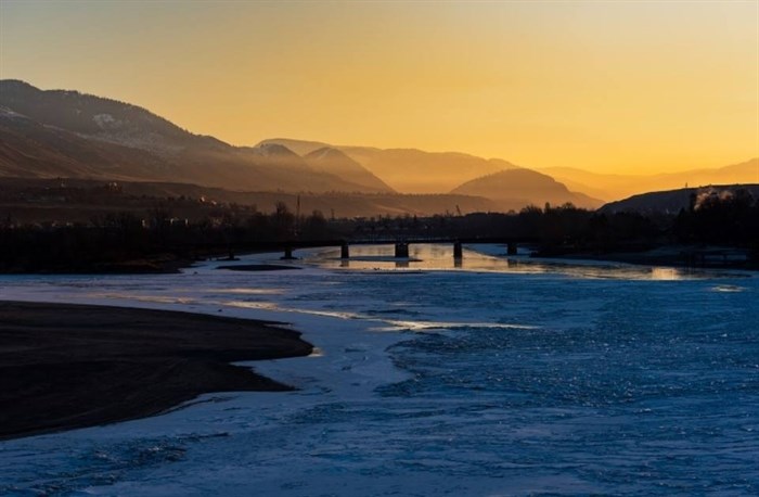 The suns rays shine through fog over the Thompson River in Kamloops on a February morning. 