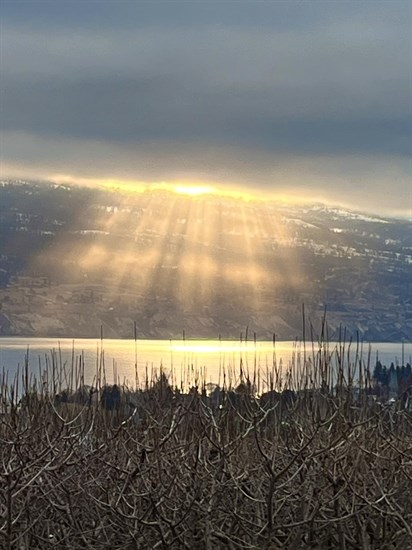 Rays of sunshine pour out from underneath clouds in Summerland. 