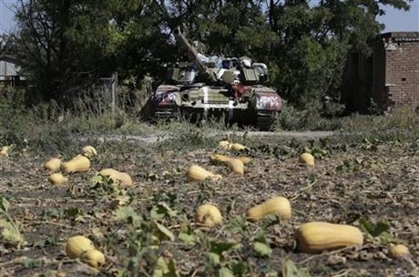 An abandoned Ukrainian army tank is seen in the village of Kominternove , Ukraine, Saturday, Sept. 6, 2014.