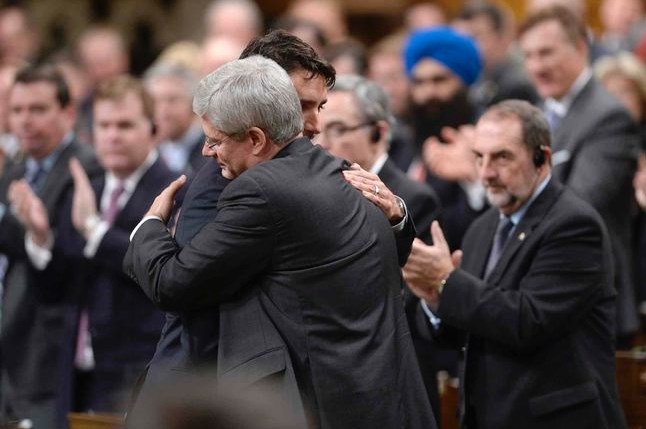 Stephen Harper hugs the leader of the Liberal Party of Canada Justin Trudeau.