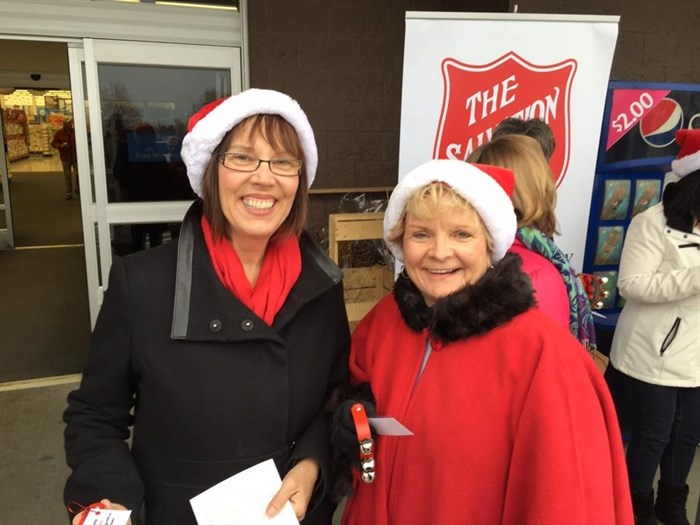 Kelowna city councillors Gail Given, left, and Maxine de Hart get in the spirit by volunteering to ring the bells as part of the Salvation Army's Christmas Kettle campaign.