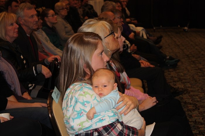 Monday's Penticton council inauguration seems to be a little more than sleepy eyed Hawksley Carlson can handle. Shown in mother Ronnie Nickel's arms, Hawksley is Mayor Jakubeit's grandson.