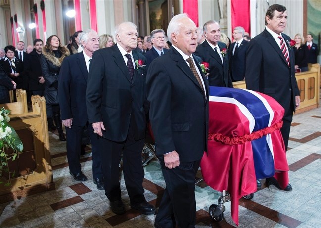 Pallbearers and former teammates (left tor right) Dickie Moore, Jean-Guy Talbot, Phil Goyette, Yvan Cournoyer, Guy Lafleur and Serge Savard carry the casket of former Montreal Canadiens captain Jean Beliveau into his funeral service at Mary Queen of the World Cathedral in Montreal, Wednesday, Dec.10, 2014. 