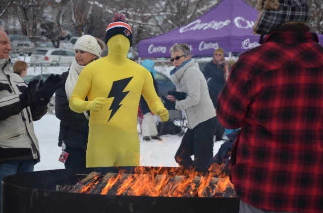 Participants—and spectators—huddled around a fire to keep warm in the -6 C weather. 