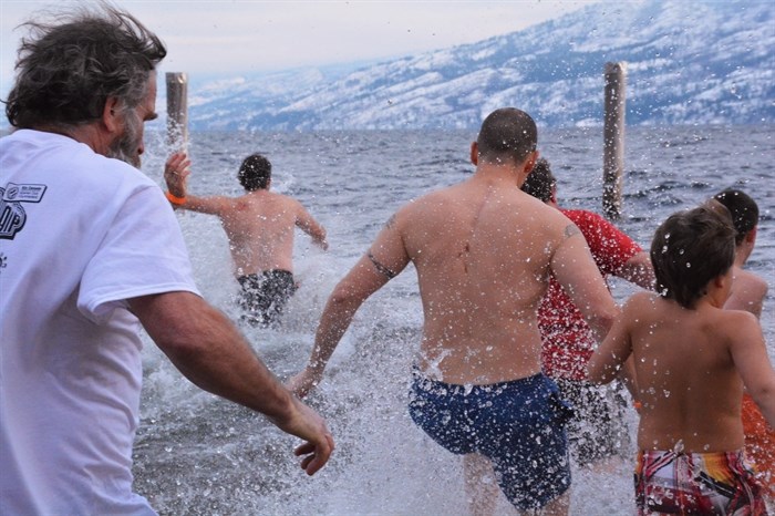 The countdown is finished and swimmers run into the lake in Peachland, January 1, 2015.