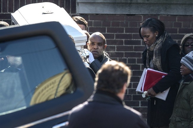 Georgette Marsh follows as pall bearers carry the casket holding her son Elijah following his memorial service in Toronto on Saturday, February 28, 2015. The three-year-old boy died after wandering away from his North York home in the early hours of a cold morning dressed only in a T-shirt, boots and a diaper.