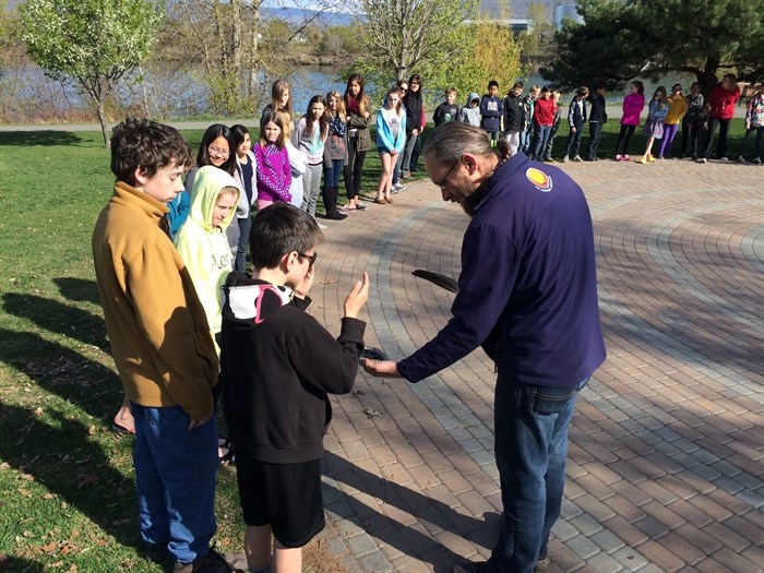 Students participate in a smudging ceremony.