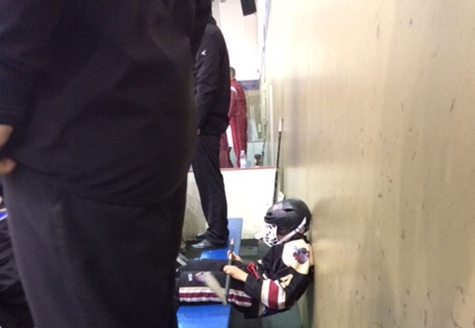 Sam Lescarbeau sits on the bench during a Knights of West Kelowna hockey game.
