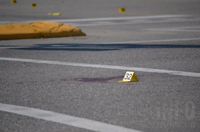Police have numerous evidence markers laid out around the scene. 