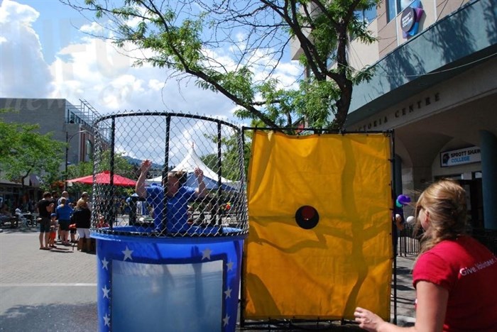 Big Brothers Big Sisters' booth complete with dunk tank, and soaking bylaw officer.