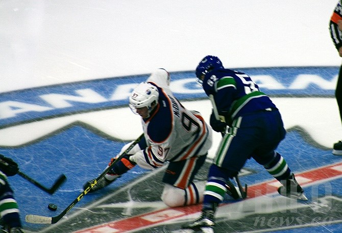 FILE PHOTO - Edmonton Oilers centre Connor McDavid drops to a knee following a faceoff against Canucks Cole Cassels during the second game of the Canucks Young Stars Classic in Penticton on Sept. 11, 2015.