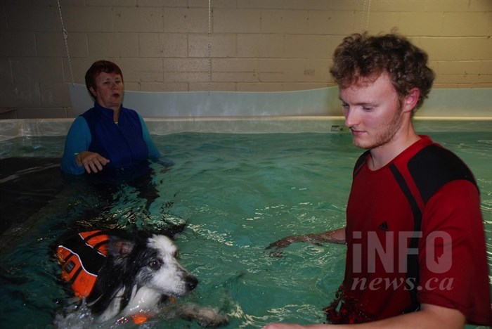Ross Marchand, left, with his dog Charlie who is undergoing rehab with canine hydrotherapist Chris McKay.