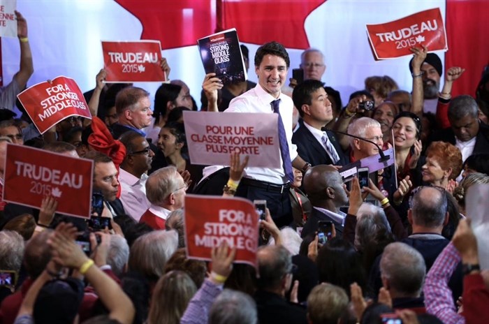 Liberal leader Justin Trudeau can be seen in this contributed photo surrounded by party supporters at a rally in Nepean, Ont., Monday, Oct. 12, 2015.