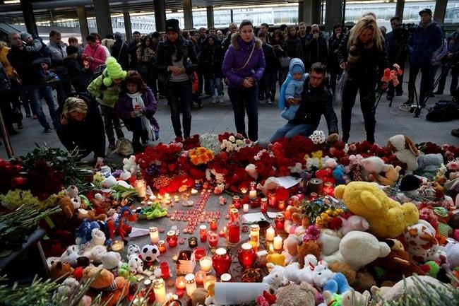 People come to lay flowers and toys at an entrance of Pulkovo airport outside St.Petersburg, Russia, during a day of national mourning for the plane crash victims, on Sunday, Nov. 1, 2015.