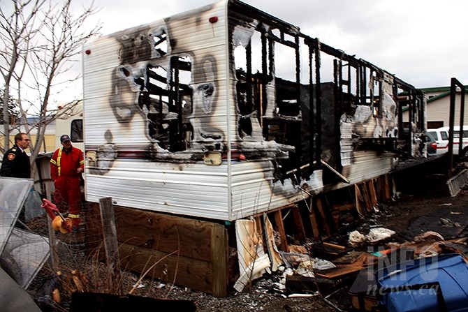 Penticton fire department officials investigate a blaze that destroyed a trailer and outbuilding, and damaged another trailer in the city's industrial park last night.