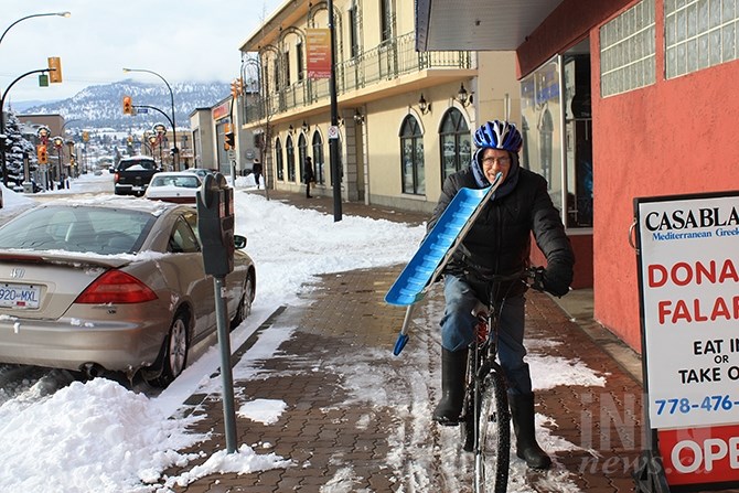 Peter Cummings was able to get around downtown Penticton on a bicycle, in spite of the weekend's heavy snow - carrying a snow shovel to boot.