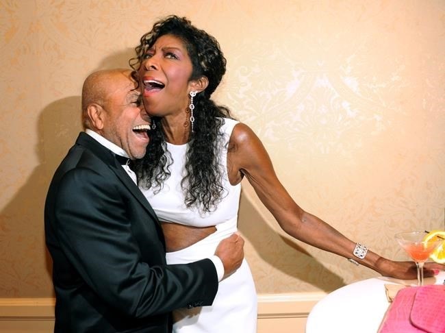 FILE PHOTO- In a Saturday, Oct. 11, 2014 file photo, Motown Records founder Berry Gordy, left, embraces singer Natalie Cole at the 2014 Carousel of Hope Ball at the Beverly Hilton Hotel, in Beverly Hills, Calif. Cole died Thursday night, Dec. 31, 2015.