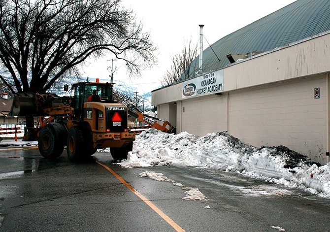 A Penticton public works crew cleans up excess snow from the roof of Memorial Arena, Friday, Jan 8, 2015.