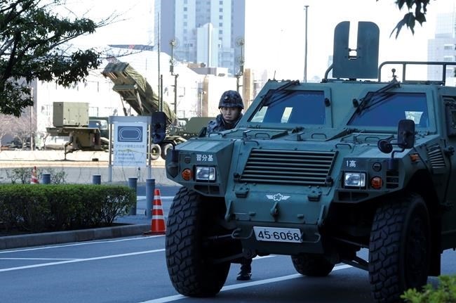 A member of the Japan Self-Defense Forces stands near a PAC-3 Patriot missile unit deployed for North Korea's rocket launch at Defense Ministry in Tokyo, Sunday, Feb. 7, 2016. North Korea on Sunday defied international warnings and launched a long-range rocket that the United Nations and others call a cover for a banned test of technology for a missile that could strike the U.S. mainland.