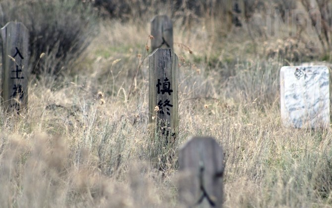 Wooden grave markers currently stand in the Chinese Cemetery.