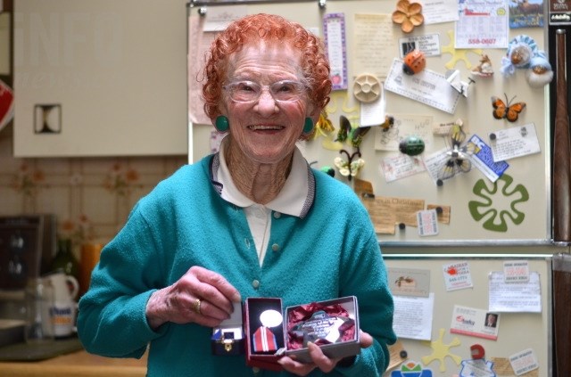 Helen Sidney holds just some of the awards she's received for community service over the years. 