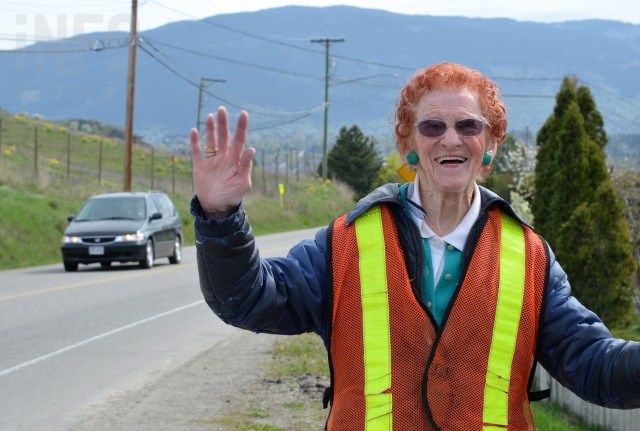 Helen Sidney, 93, waves to passersby on Bella Vista Road in Vernon. 