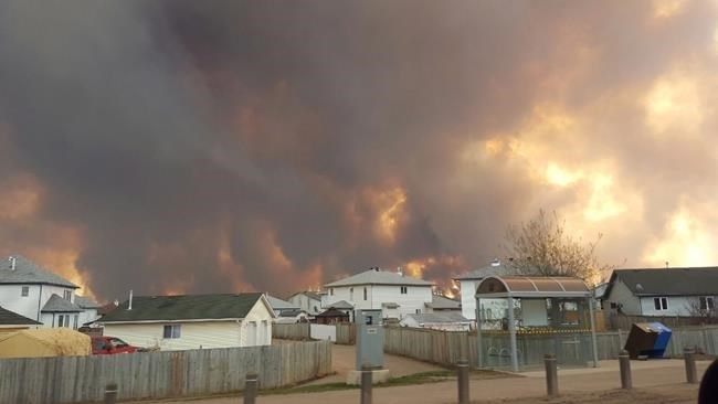 A wall of fire rages outside of Fort McMurray, Alta. on Tuesday, May 3, 2016. 