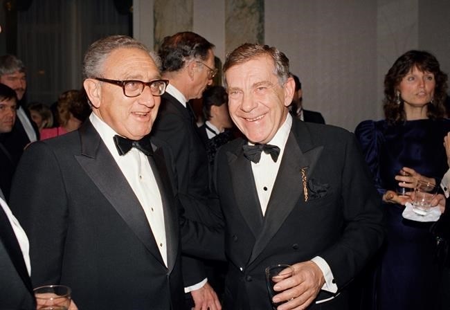FILE PHOTO - In this March 3, 1988 file photo, Henry Kissinger, left, and Morley Safer of CBS' 