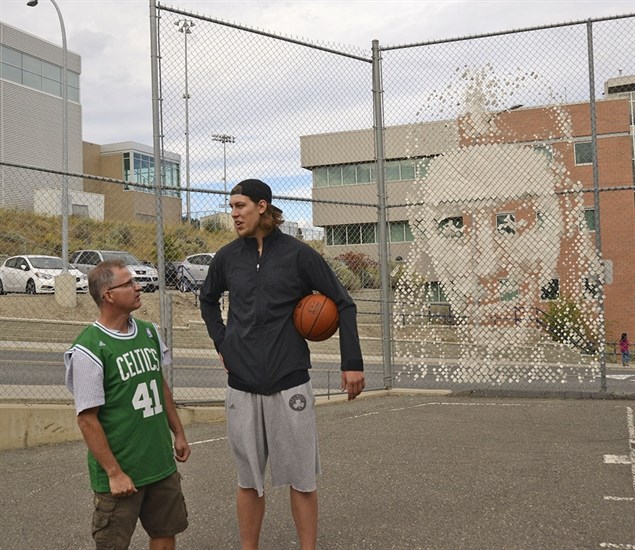 Artist Bill Frymire stands with Kelly Olynyk at the site of Frymire's new work located at the outdoor basketball courts at TRU. 