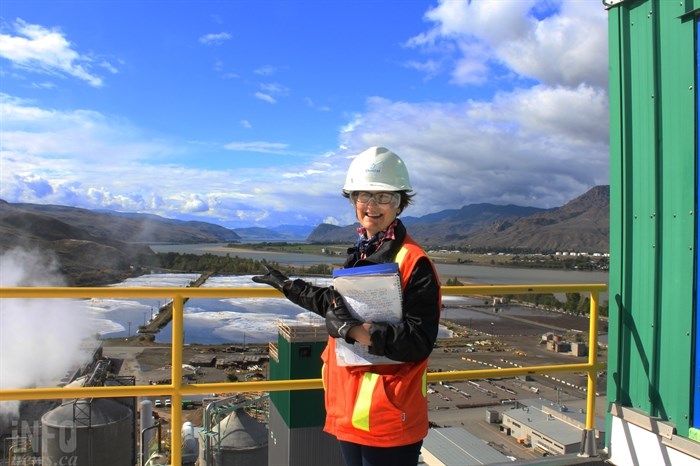 Kristin Dangelmaier stands at the top of the Domtar building in Kamloops, in front of three of the pulp treatment ponds.