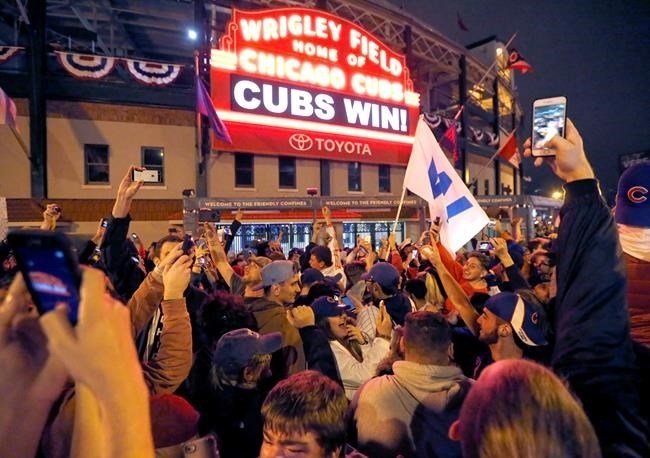 Chicago Cubs fans celebrate in front of Wrigley Field in Chicago on Wednesday, Nov. 2, 2016, after the Cubs defeated the Cleveland Indians 8-7 in Game 7 of the baseball World Series in Cleveland.