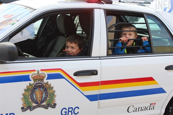 Corbin (left) and Brody (right) got to sit in the police cruiser during Kamloops RCMP's Stuff the Cruiser event on Saturday, Dec. 10, 2016.