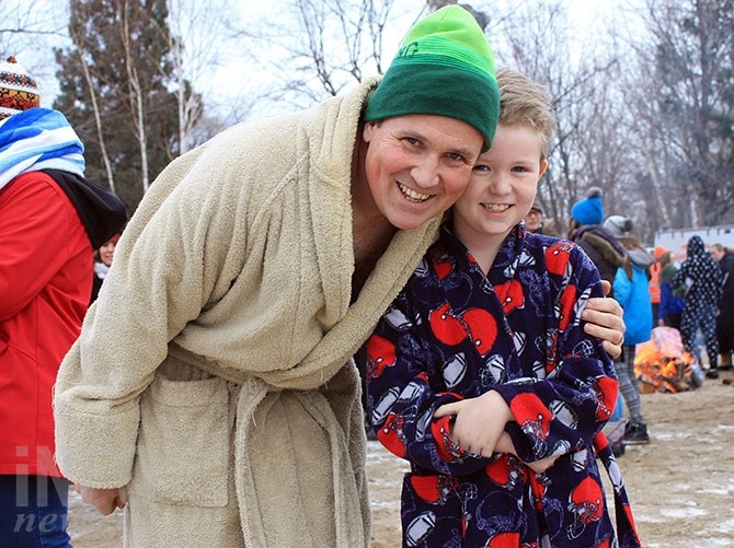 Father - son duo Brad and Logan Borsheim prepare for a New Year's plunge.