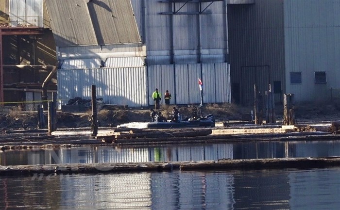 RCMP, the B.C. Coroners Service and WorkSafe B.C. are investigating the sinking of a tugboat at the Tolko Industries mill in Kelowna. The dive team is pictured at the mill the day after the sinking on Tuesday, Jan. 31, 2017.