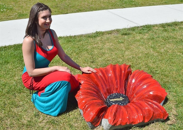 Artist Amanda Shatzko with a cement poppy she created at Vernon Secondary School in 2016. 