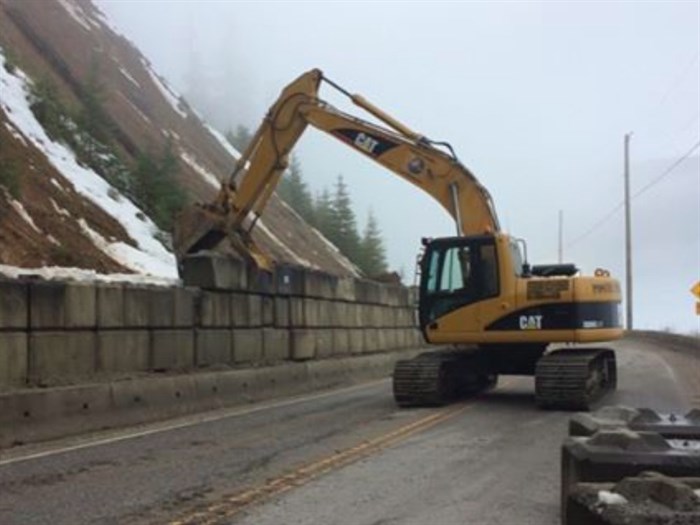 An excavator was used to repair the catchment wall. 