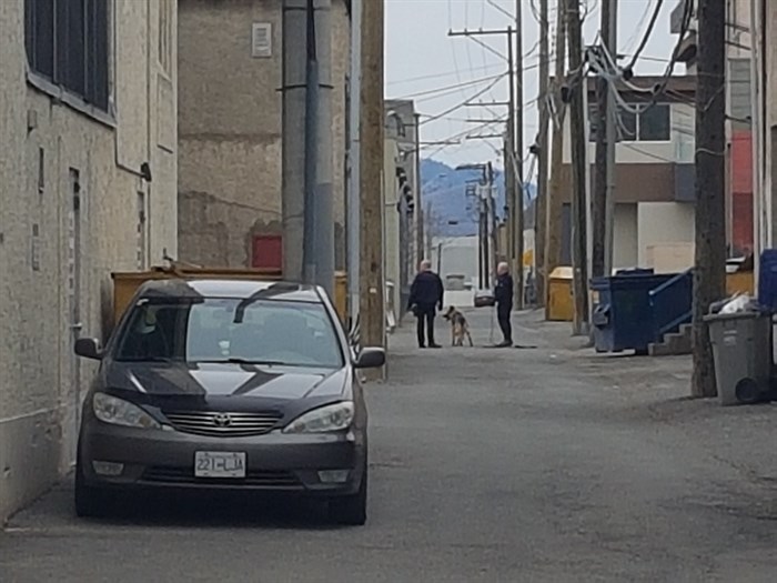 Officers search alleys in downtown Kamloops for the suspect that robbed TD Canada Trust around 5:16 p.m. on Friday, March 31, 2017. 
